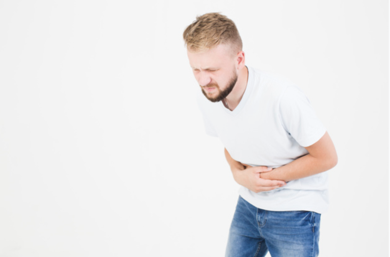 Man holding his stomach due to pain