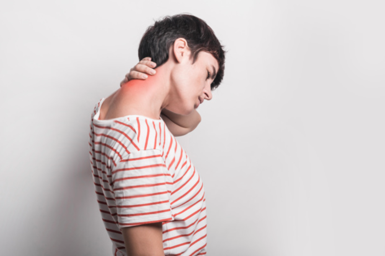Woman holding her neck due to pain